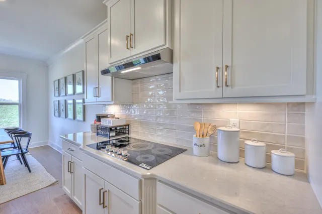 a kitchen with a stove and cabinets