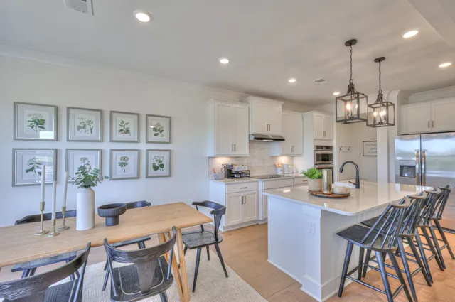 a kitchen with a dining table chairs and view kitchen