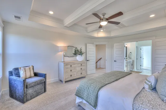 a bedroom with a bed and ceiling fan