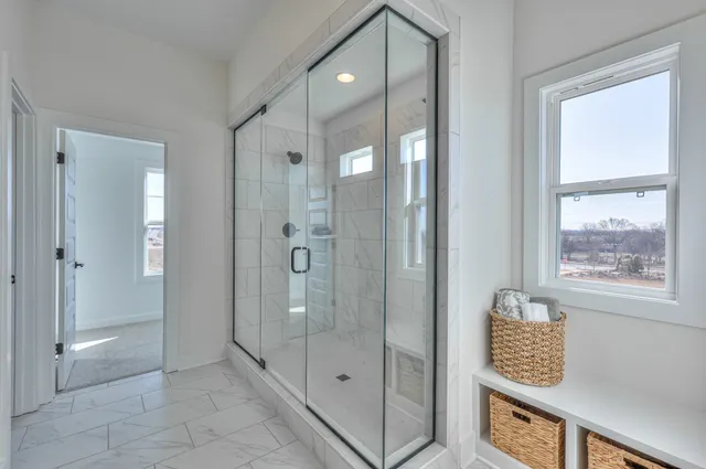 a view of an entryway with a cabinet and mirror