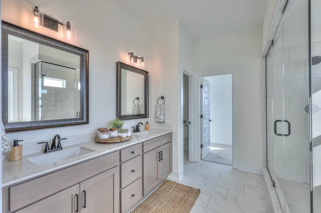 a spacious bathroom with a granite countertop sink mirror and double