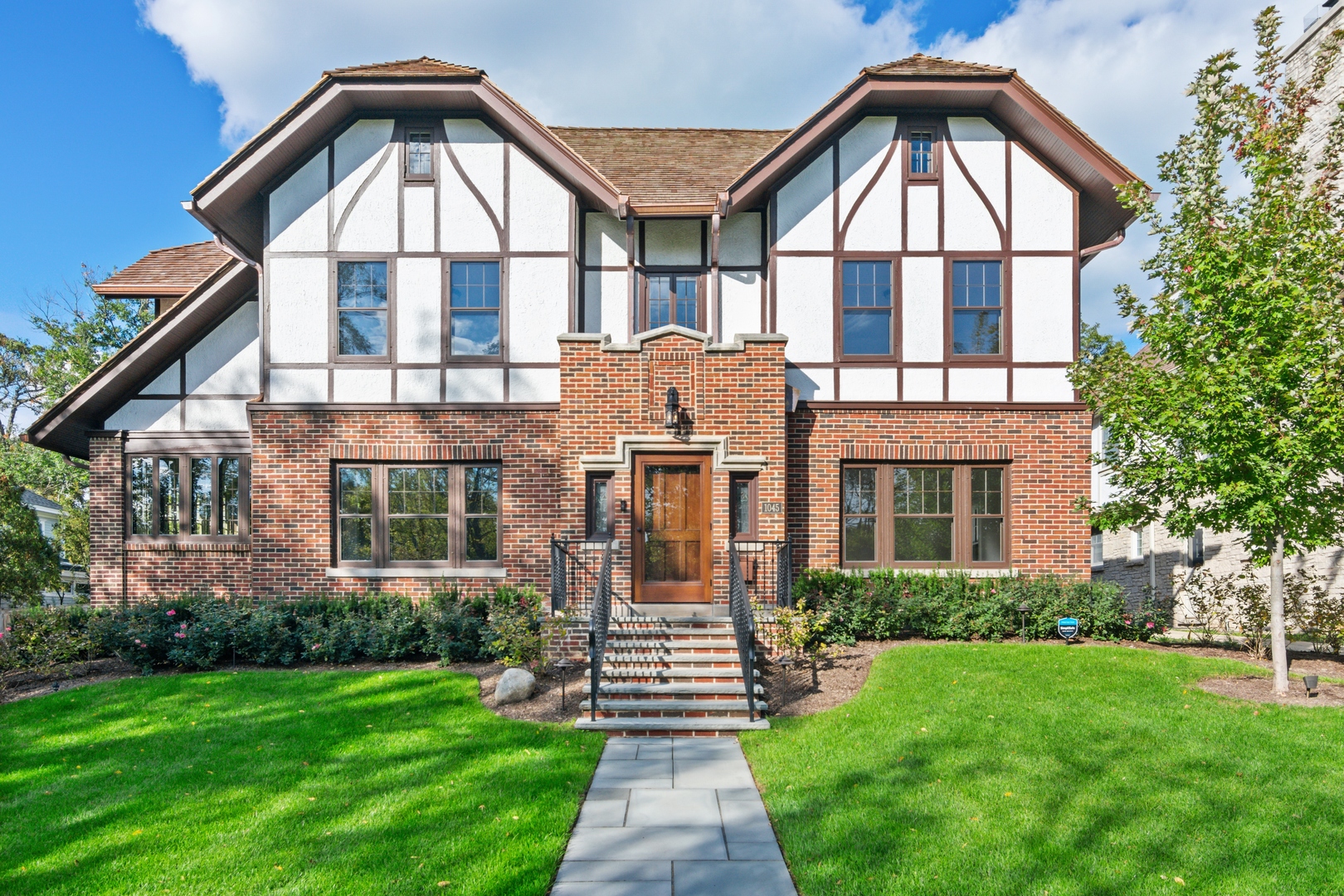 1045 Pine Street Winnetka, IL 60093 - Photo 2 of 38 a front view of a house with yard