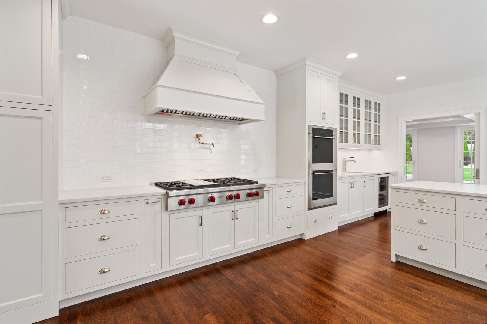1045 Pine Street Winnetka, IL 60093 - Photo 11 of 38 a kitchen with stainless steel appliances a stove and white cabinets