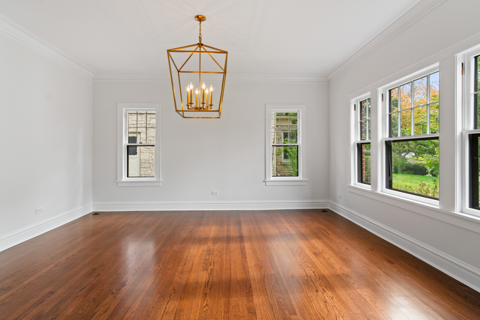 1045 Pine Street Winnetka, IL 60093 - Photo 9 of 38 a view of an empty room with wooden floor and a window