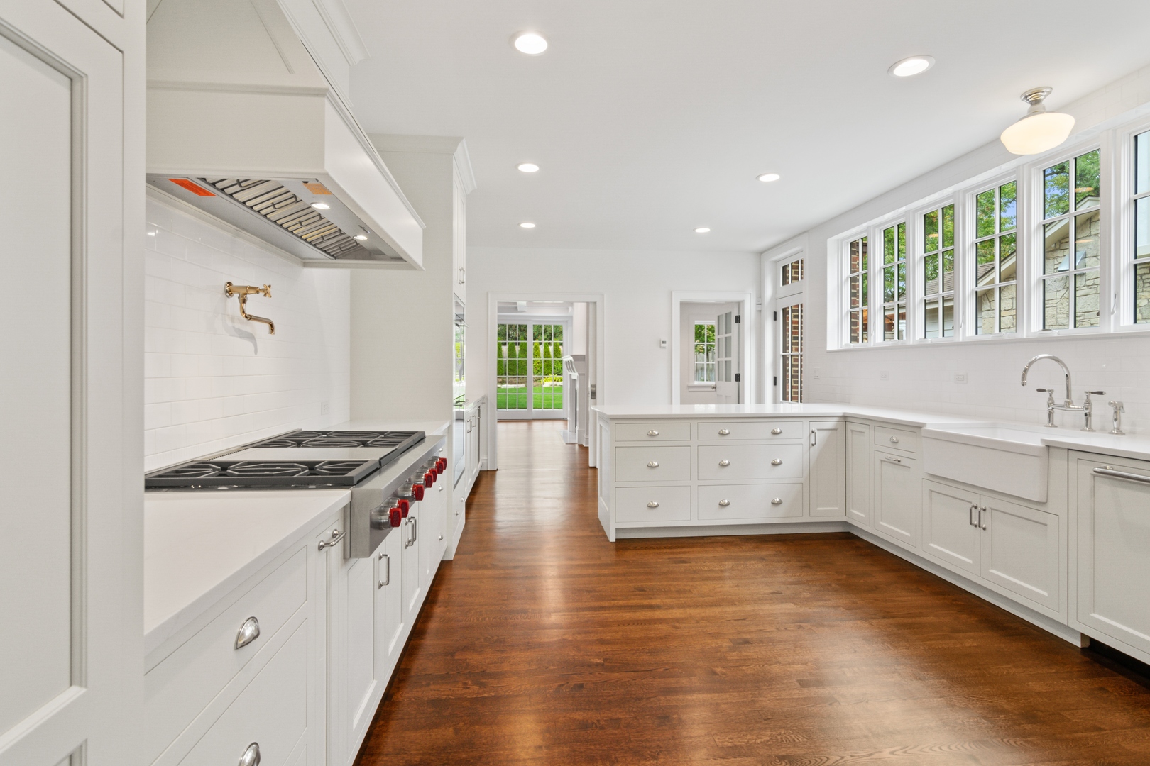 1045 Pine Street Winnetka, IL 60093 - Photo 10 of 38 a kitchen with stove a sink and dishwasher with wooden floor