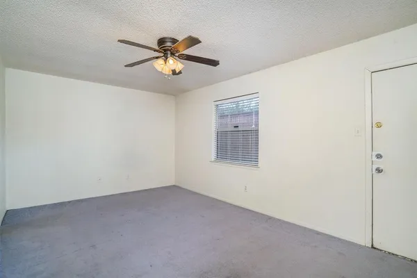 a view of a livingroom with a ceiling fan and window