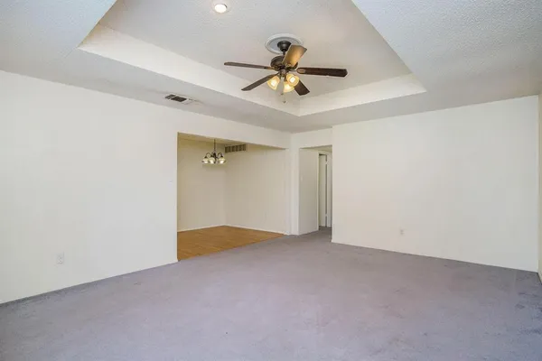 a view of a livingroom with a ceiling fan and window