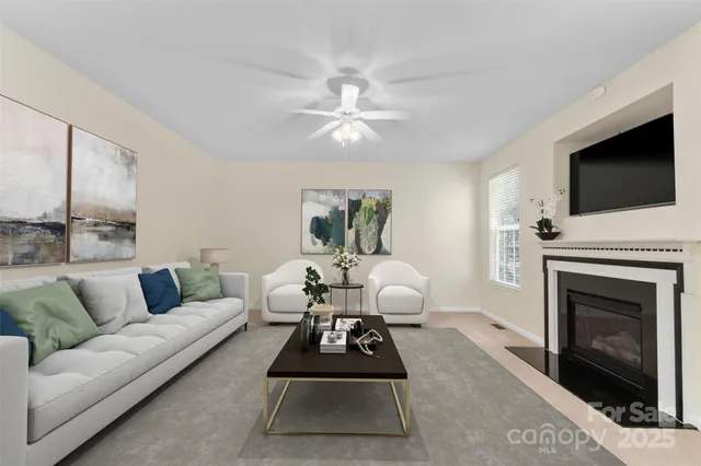 a living room with furniture a flat screen tv and a fireplace