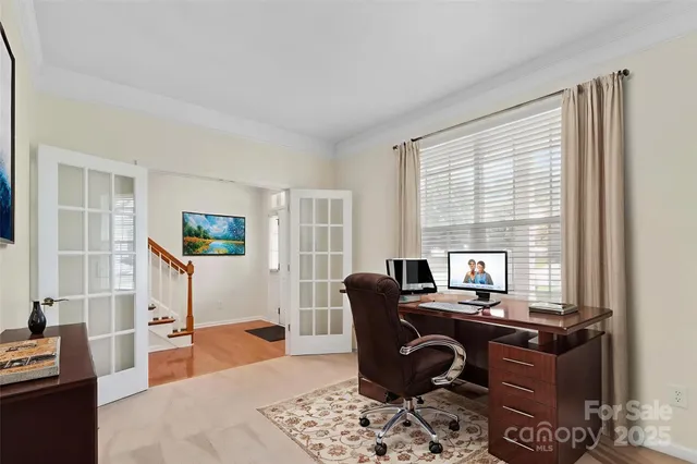 a view of a workspace with furniture and a window