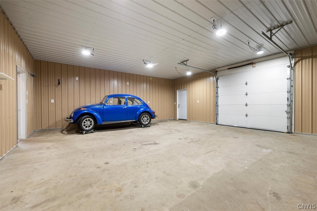 1322 Sawmill Road Sangerfield, NY 13480 - Photo 49 of 50 A spacious outbuilding provides ample concrete flooring and high ceilings for versatile storage needs.
