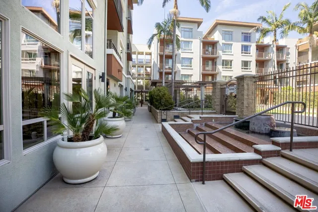 a view of a patio with couches and potted plants