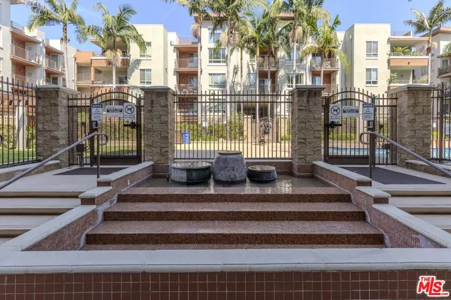 a view of a patio with chairs and potted plants