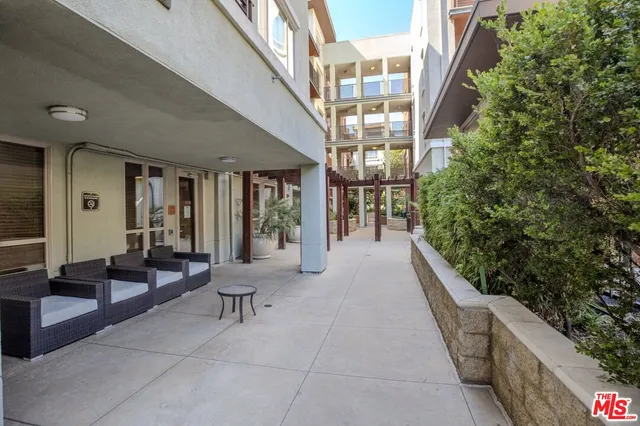 a view of a patio with table and chairs