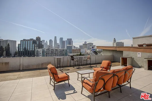 a view of a balcony with chairs and wooden floor