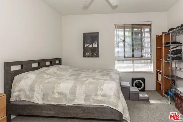 a bedroom with a bed and a mirror