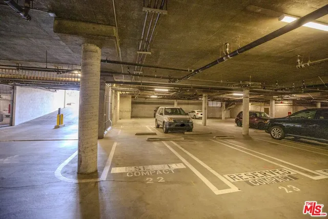 a view of parking garage with cars parked