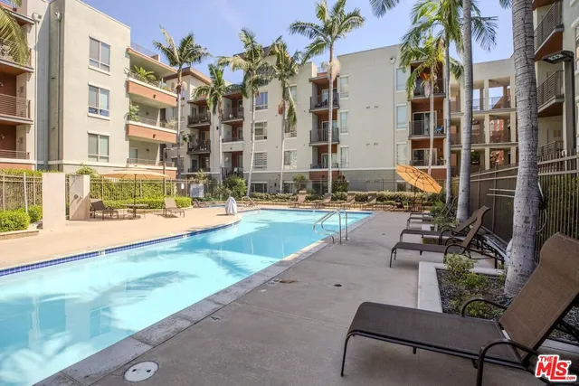 a view of a swimming pool with outdoor seating