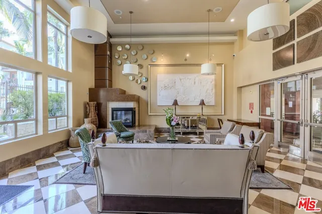 a living room with fireplace furniture and a large window