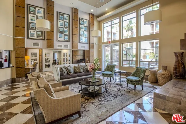 a living room with furniture and large windows