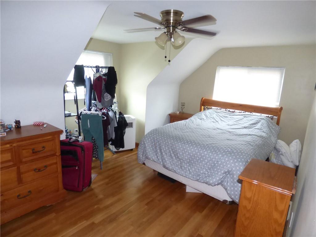 41 Charlton Street, Unit 2 Pittsburgh, PA 15204 - Photo 2 of 17 a bedroom with a bed and a chandelier