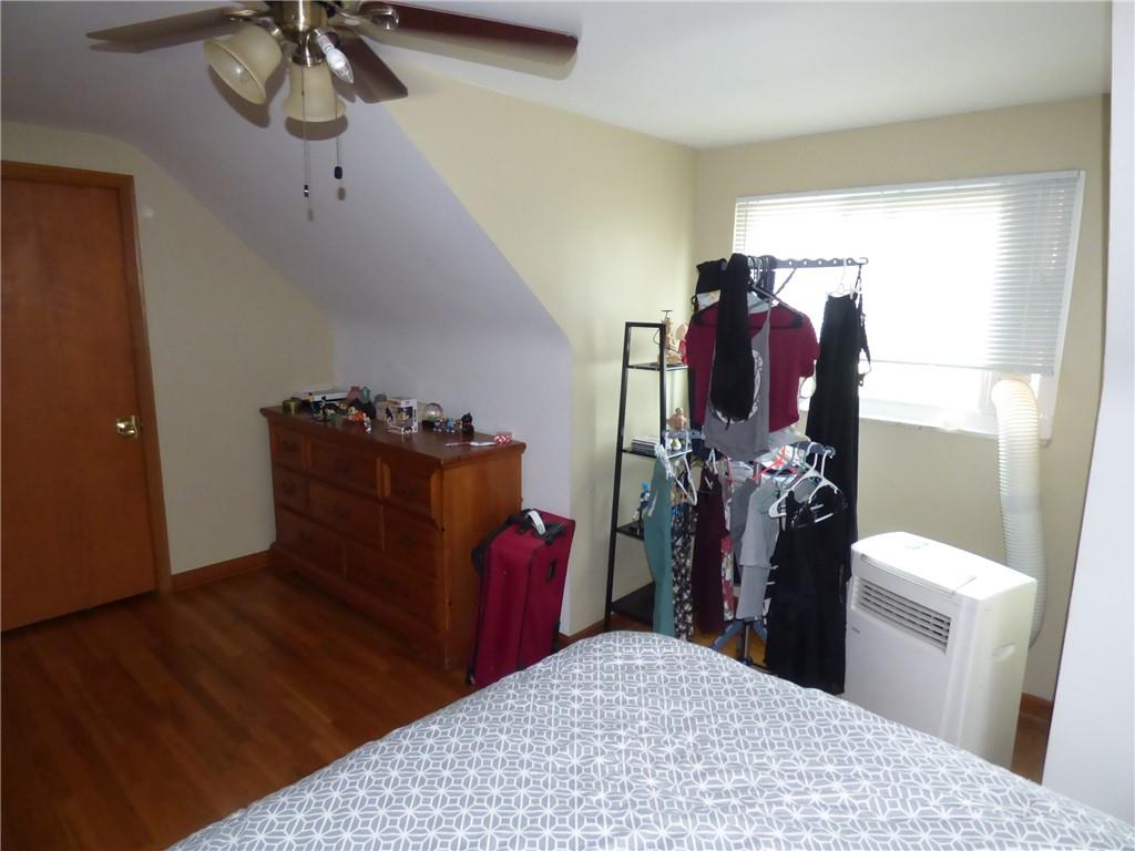 41 Charlton Street, Unit 2 Pittsburgh, PA 15204 - Photo 3 of 17 a bedroom with a bed and a chandelier