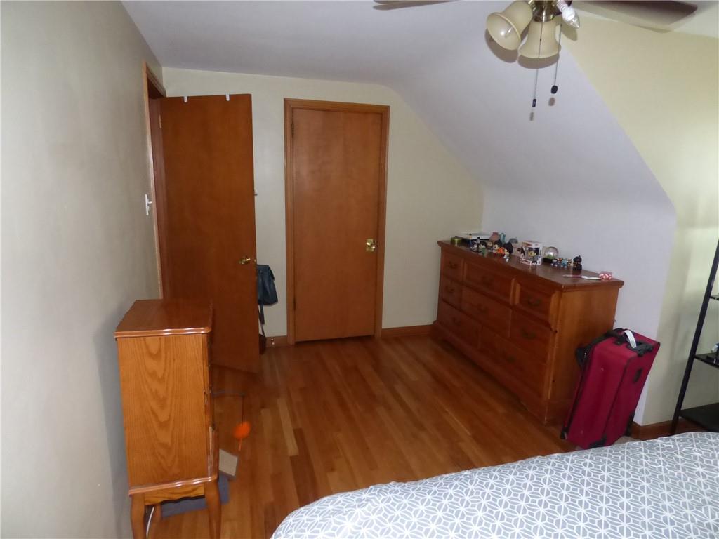 41 Charlton Street, Unit 2 Pittsburgh, PA 15204 - Photo 4 of 17 a bedroom with a bed and wooden floor