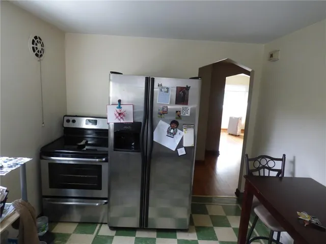 a kitchen with stainless steel appliances granite countertop a stove and a refrigerator