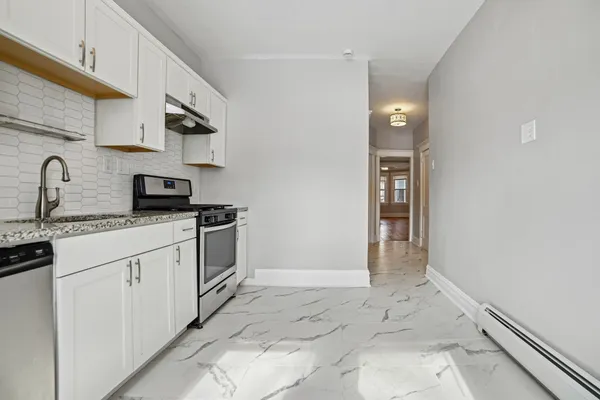 a kitchen with stainless steel appliances granite countertop a sink and cabinets