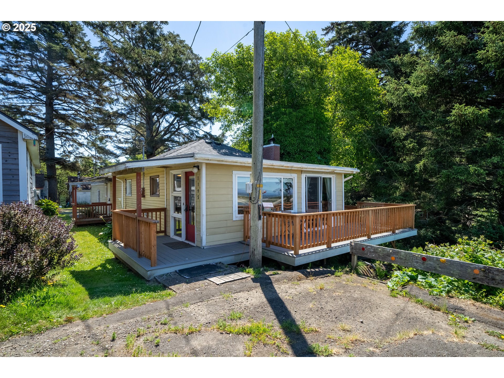 1195 3rd Street Netarts, OR 97141 - Photo 1 of 35 a front view of a house with garden