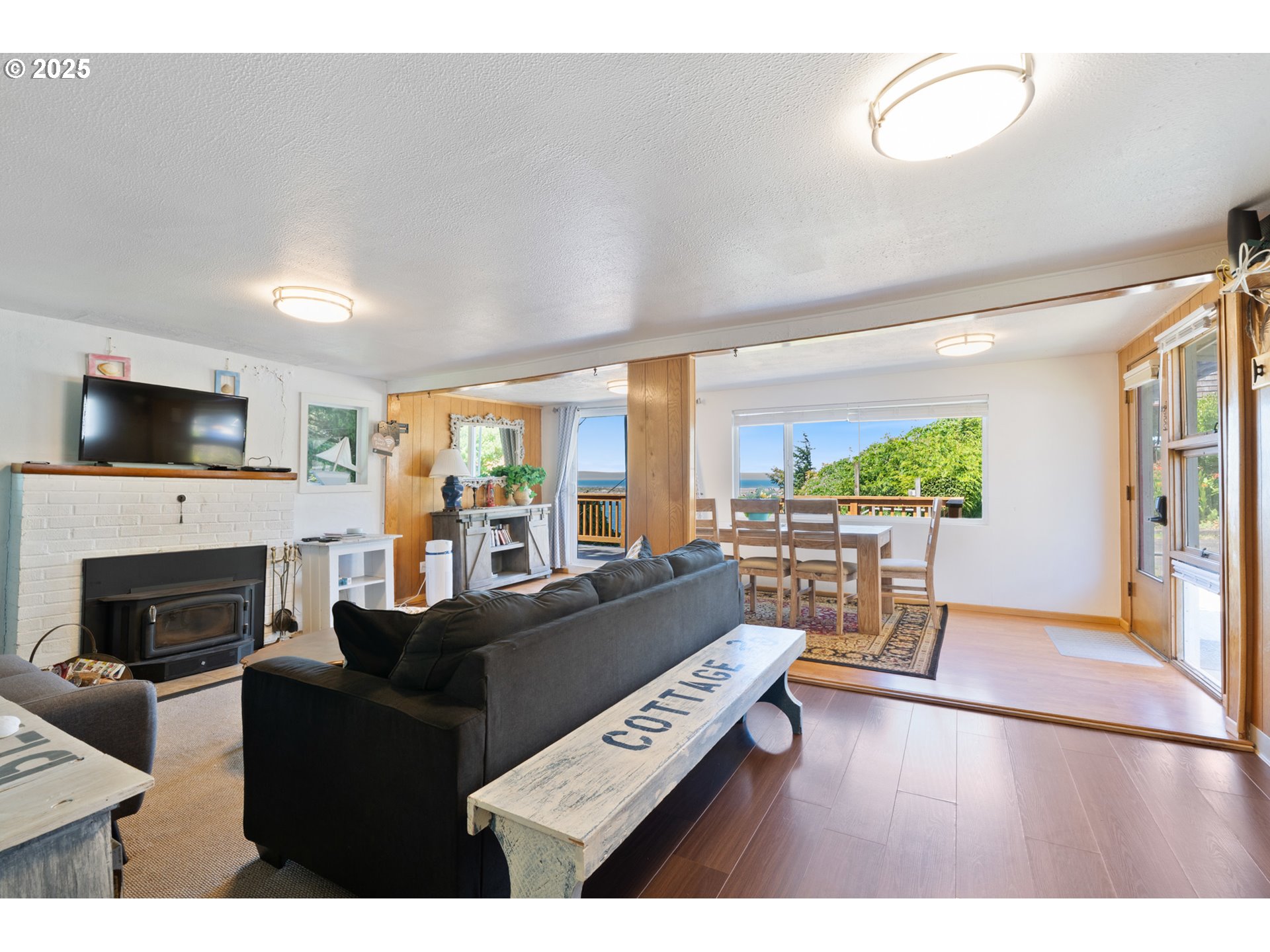 1195 3rd Street Netarts, OR 97141 - Photo 14 of 35 a living room with furniture a fireplace and a flat screen tv