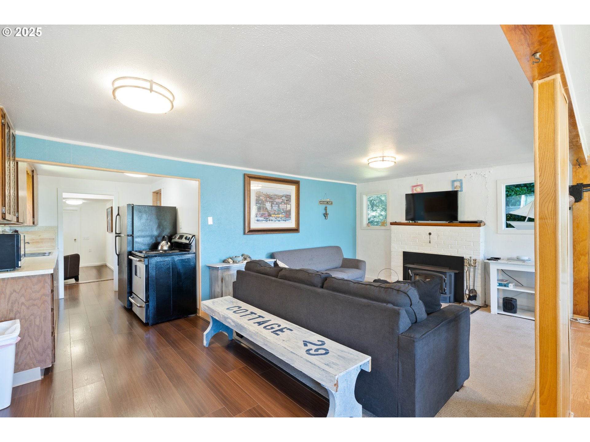 1195 3rd Street Netarts, OR 97141 - Photo 15 of 35 a living room with furniture a fireplace and a flat screen tv