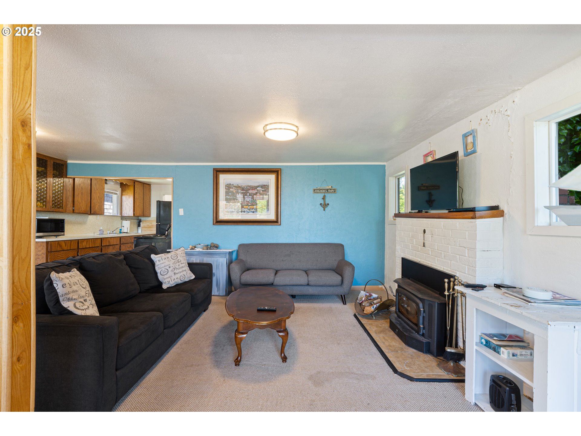 1195 3rd Street Netarts, OR 97141 - Photo 17 of 35 a living room with furniture and a fireplace