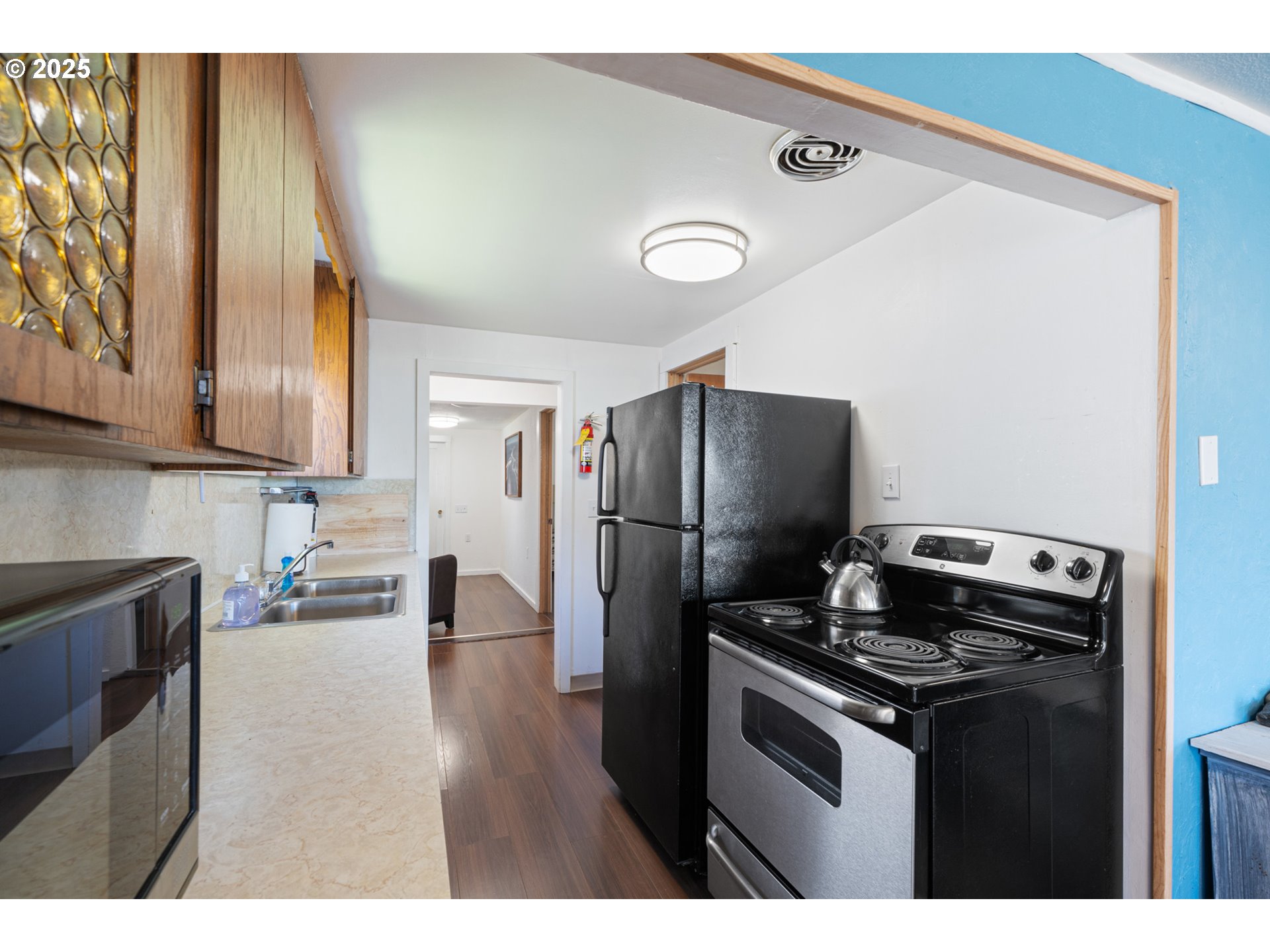 1195 3rd Street Netarts, OR 97141 - Photo 20 of 35 a kitchen with stainless steel appliances granite countertop a refrigerator stove and sink