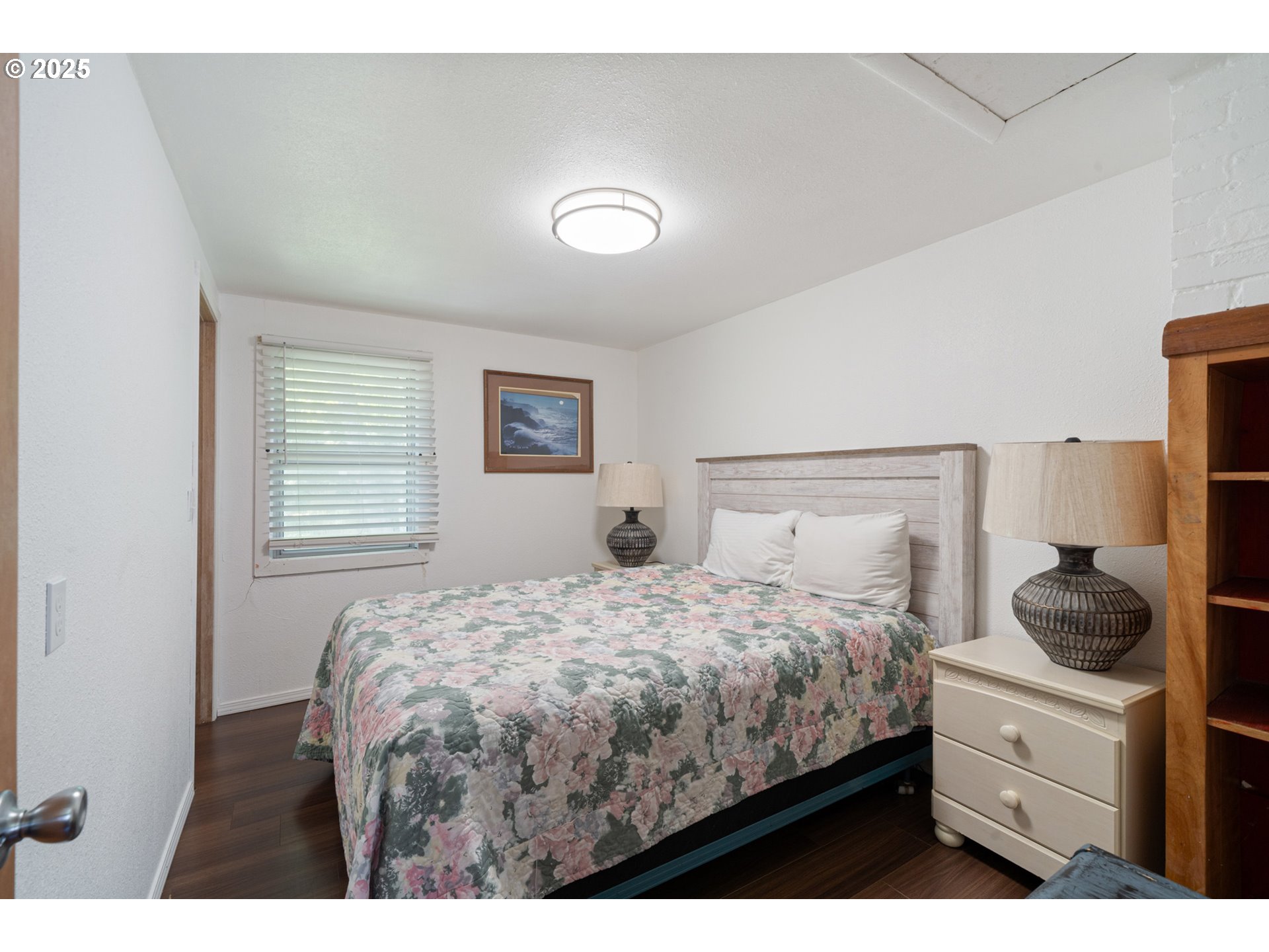 1195 3rd Street Netarts, OR 97141 - Photo 21 of 35 a bedroom with a bed and a window