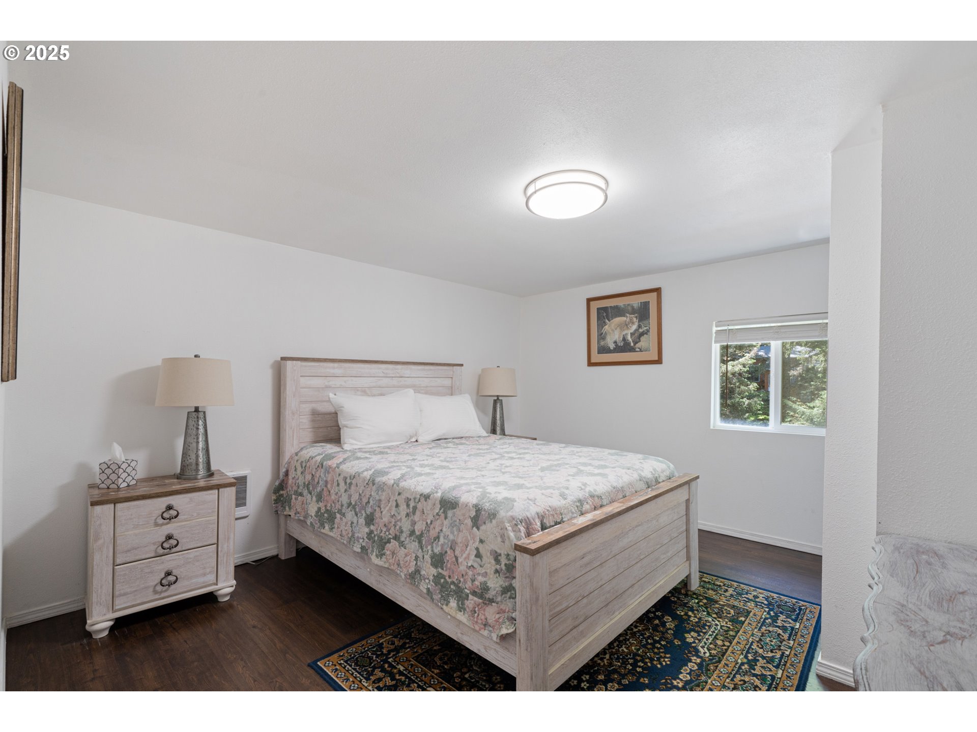 1195 3rd Street Netarts, OR 97141 - Photo 24 of 35 a bedroom with a bed and a night stand