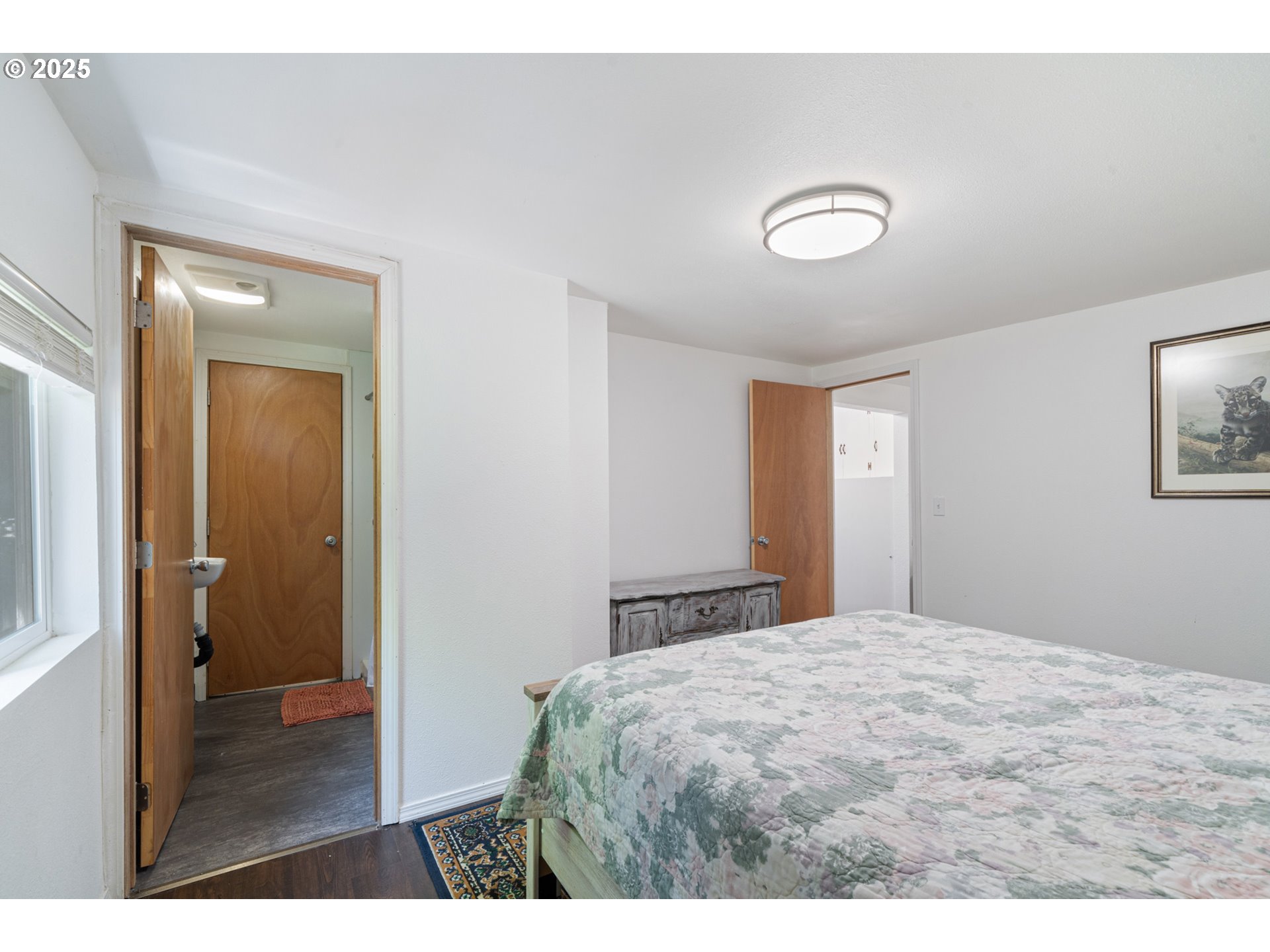 1195 3rd Street Netarts, OR 97141 - Photo 25 of 35 a bedroom with a bed and a table