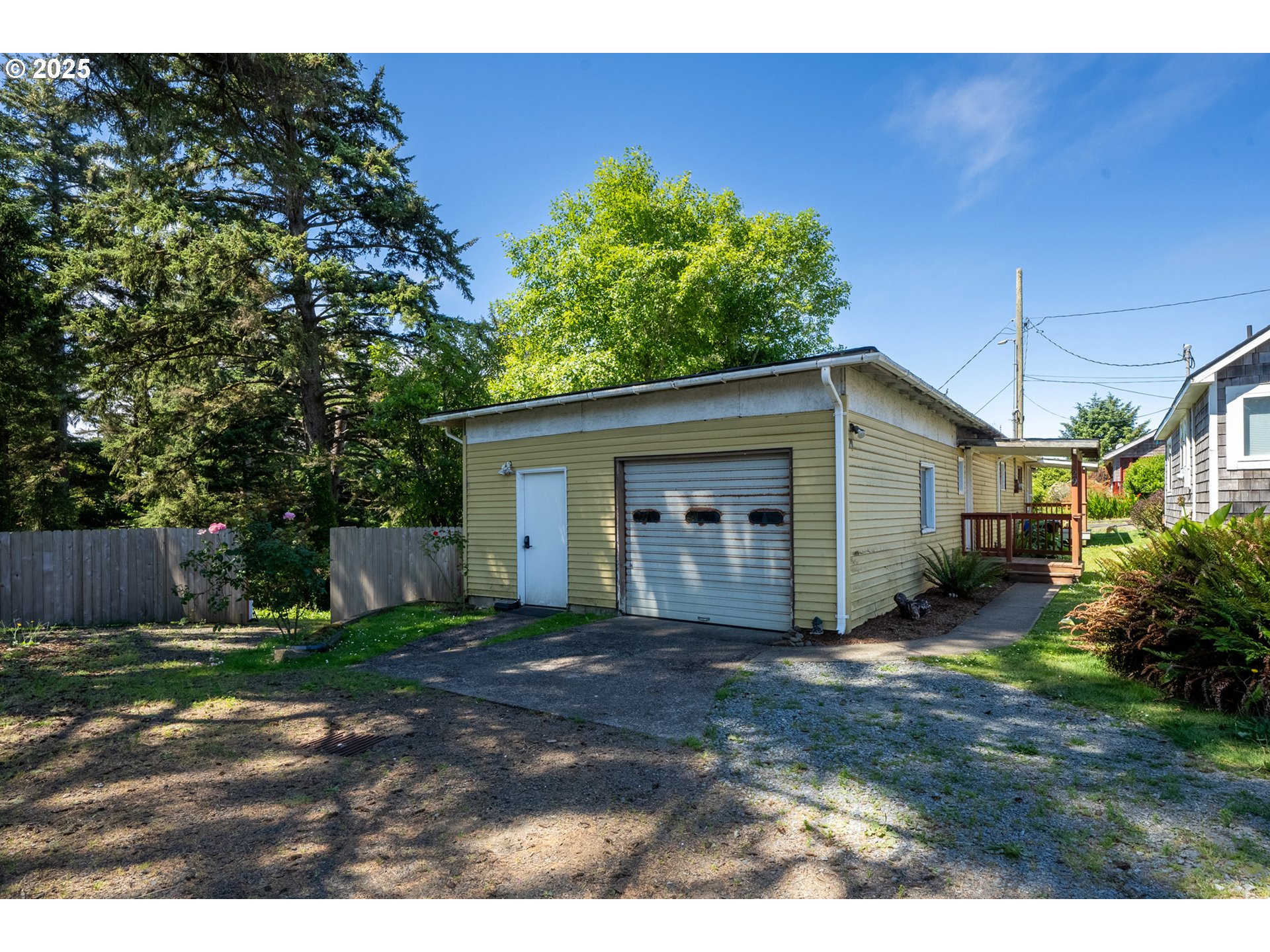 1195 3rd Street Netarts, OR 97141 - Photo 29 of 35 a view of a yard in front of a house with large tree