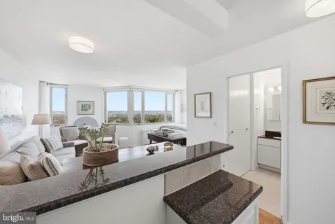a kitchen with granite countertop white cabinets and white appliances