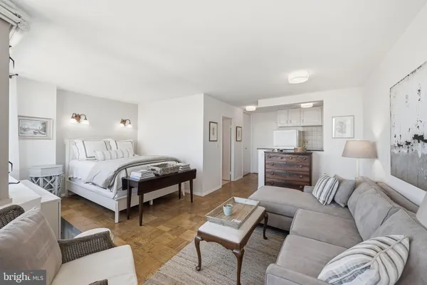 a bedroom with a bed couch and a window