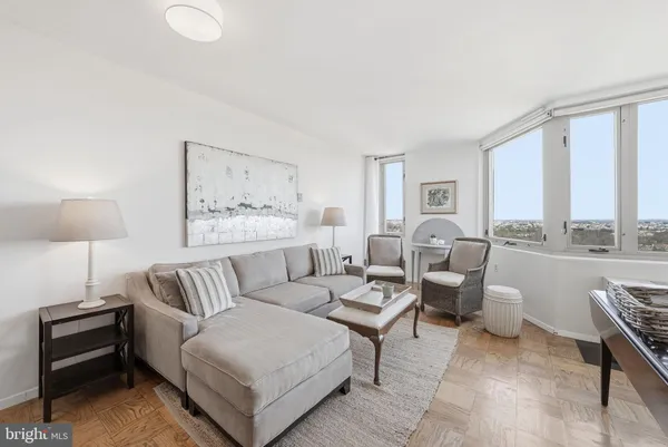 a living room with furniture and a large window