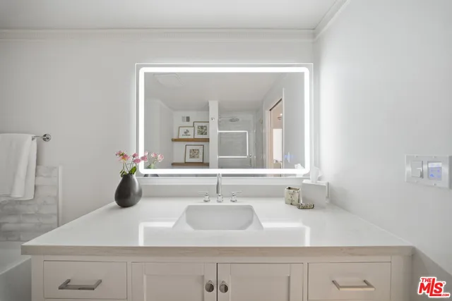 a bathroom with a sink and a mirror