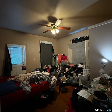 a bedroom with a bed and a chandelier