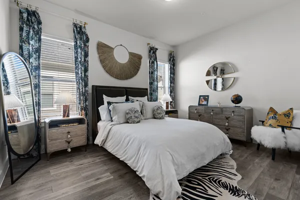 a bedroom with bed and a mirror