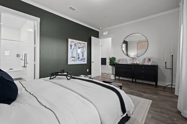 a bedroom with a bed and a mirror