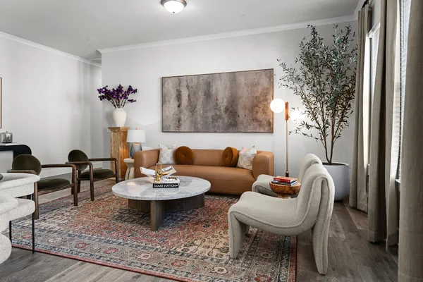 a living room with furniture and a potted plant