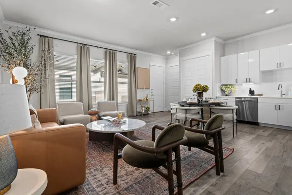 a living room with furniture and floor to ceiling windows