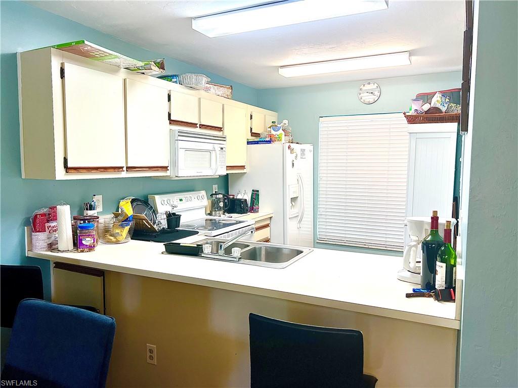 a kitchen with a sink cabinets and window