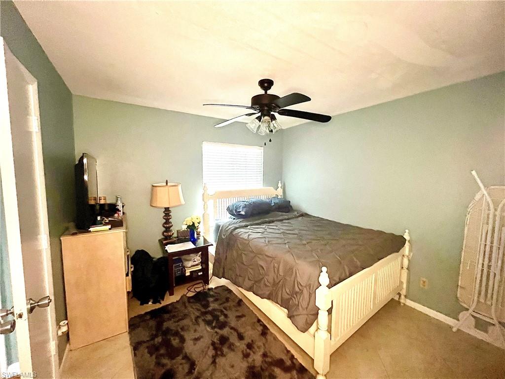 2207 San Marco Road, Unit 4104 Marco Island, FL 34145 - Photo 13 of 21 a bedroom with a bed and a chandelier