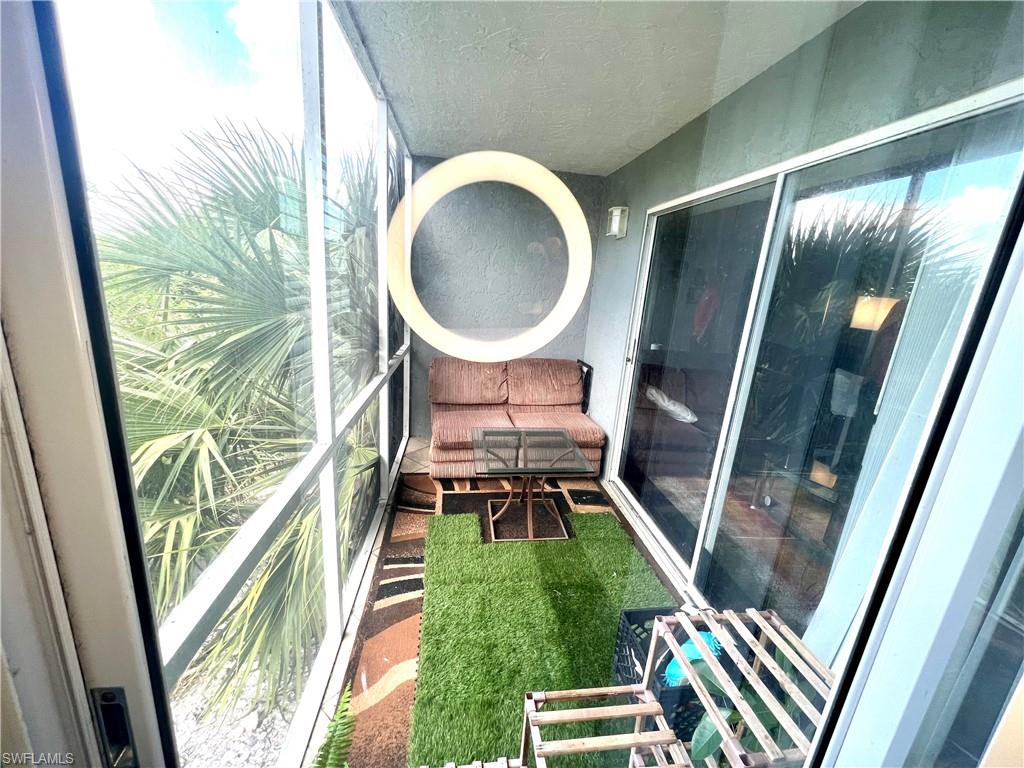2207 San Marco Road, Unit 4104 Marco Island, FL 34145 - Photo 16 of 21 a living room with a rug and a garden