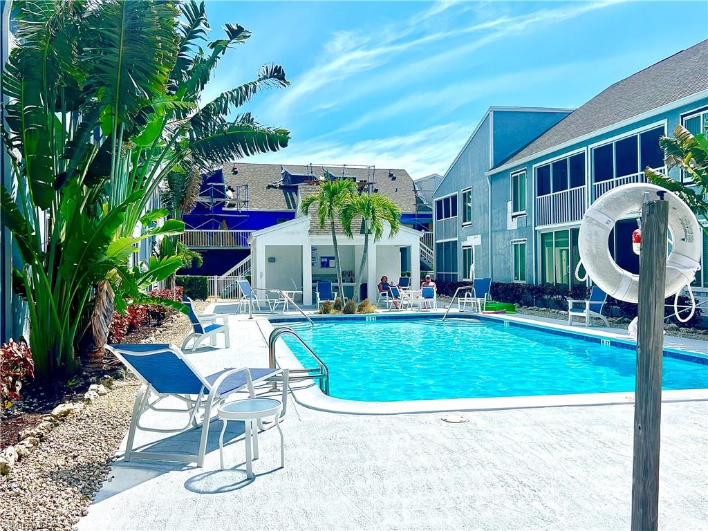 2207 San Marco Road, Unit 4104 Marco Island, FL 34145 - Photo 19 of 21 a view of a chairs and table in backyard